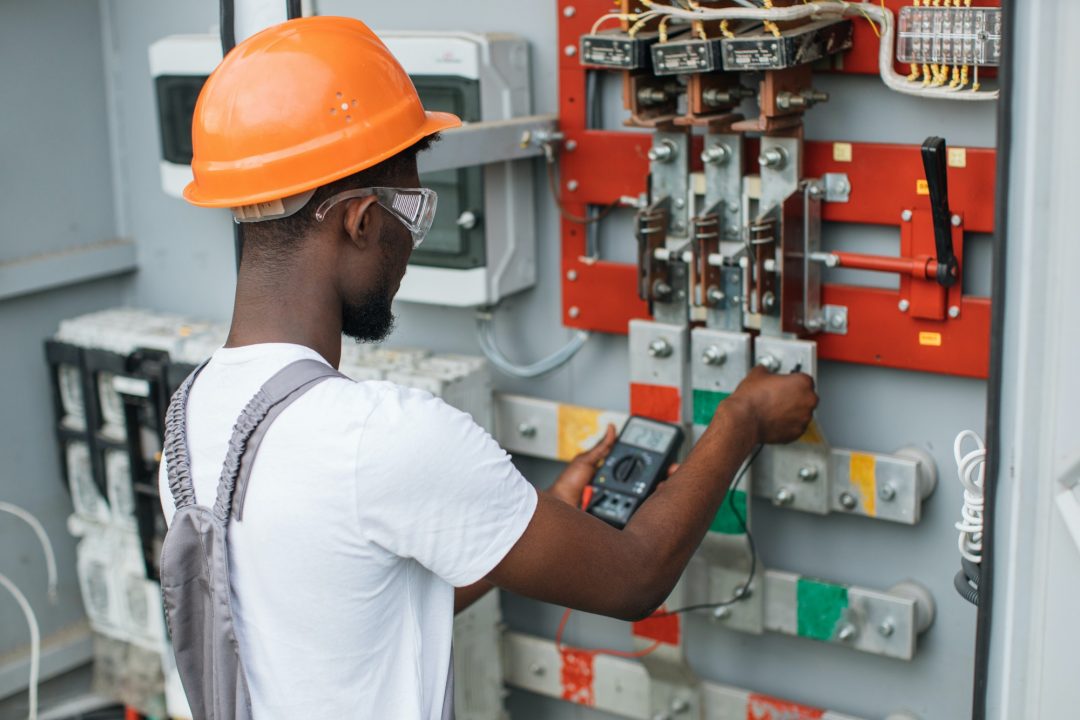 electrician-checking-voltage-in-switchgear-at-solar-station.jpg